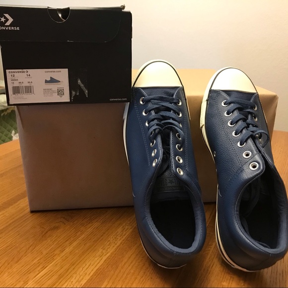 brown and blue leather converse